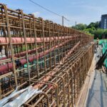 Ducts for a post-tensioning system laid within a long rebar cage before concrete is poured.