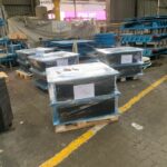 Finished elastomeric bearing pads packaged and organized in a warehouse awaiting shipment.