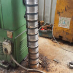 A close-up of a multi-stage hydraulic jack, a key component of heavy-duty bridge construction equipment.